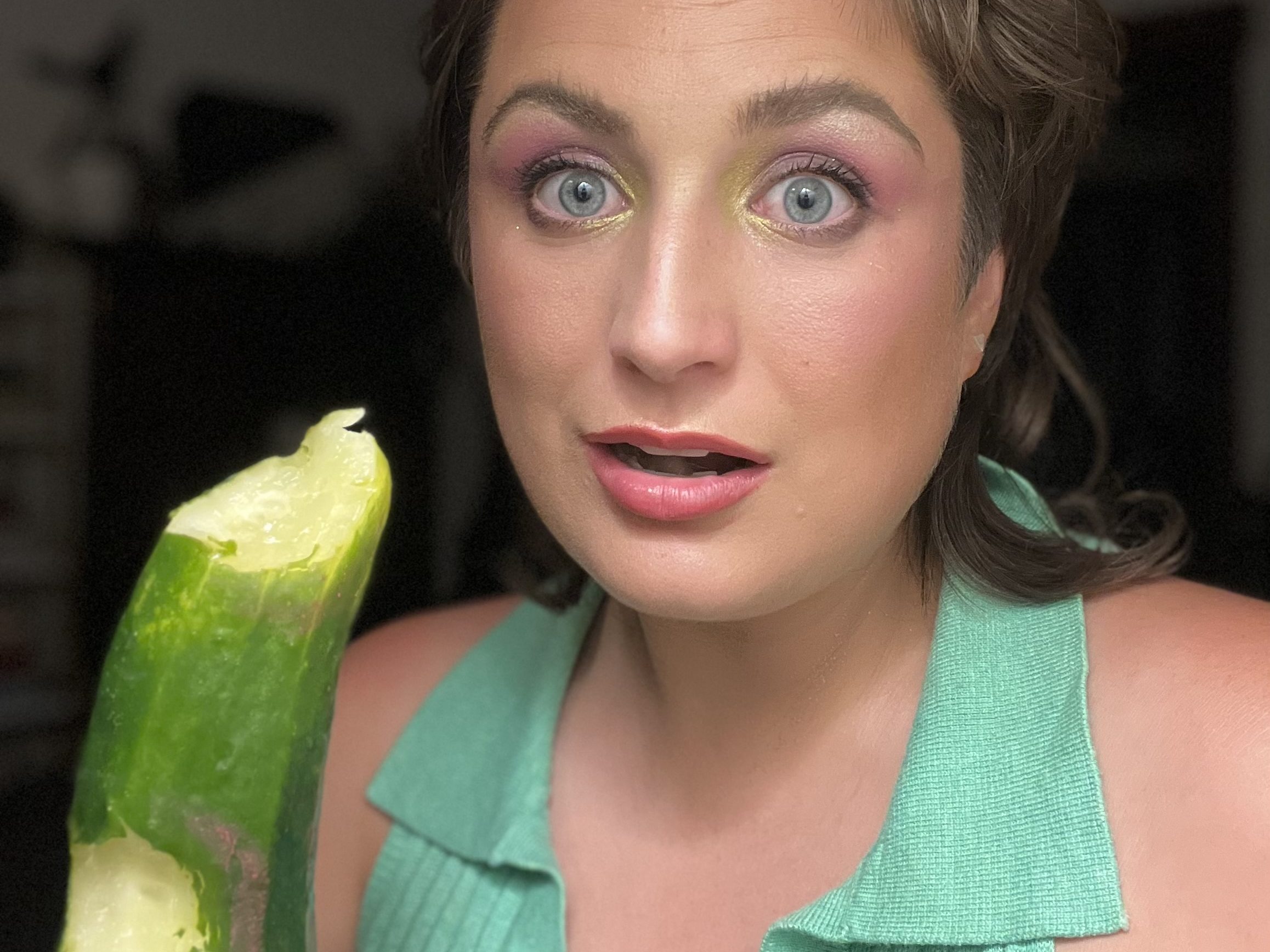 Liz Butler poses with a munched on cucumber.